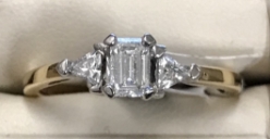 1/2cttw Emerald cut with Trillons Diamond ring 